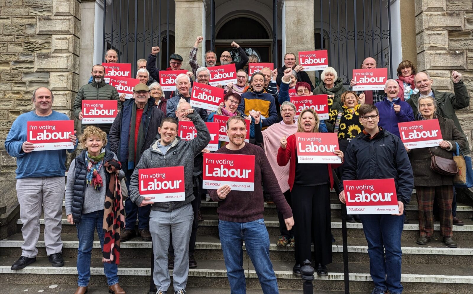 Group of local Labour activists with Vote Labour signs